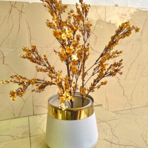 Yellow cherry blossom stems with golden strip white planter